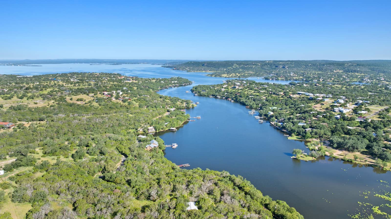 Aerial view of a blue inlet and wooded shoreline at Lake Buchanan in the Texas Hill Country