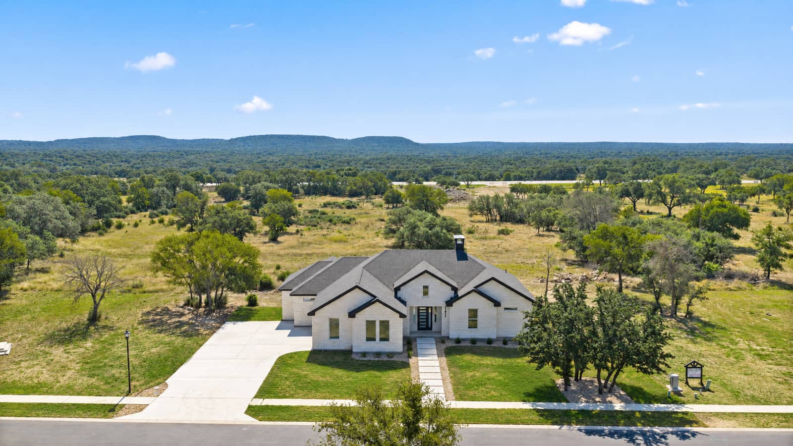 Landscaped aerial front view of 258 Sunday Drive and the surrounding Hill Country