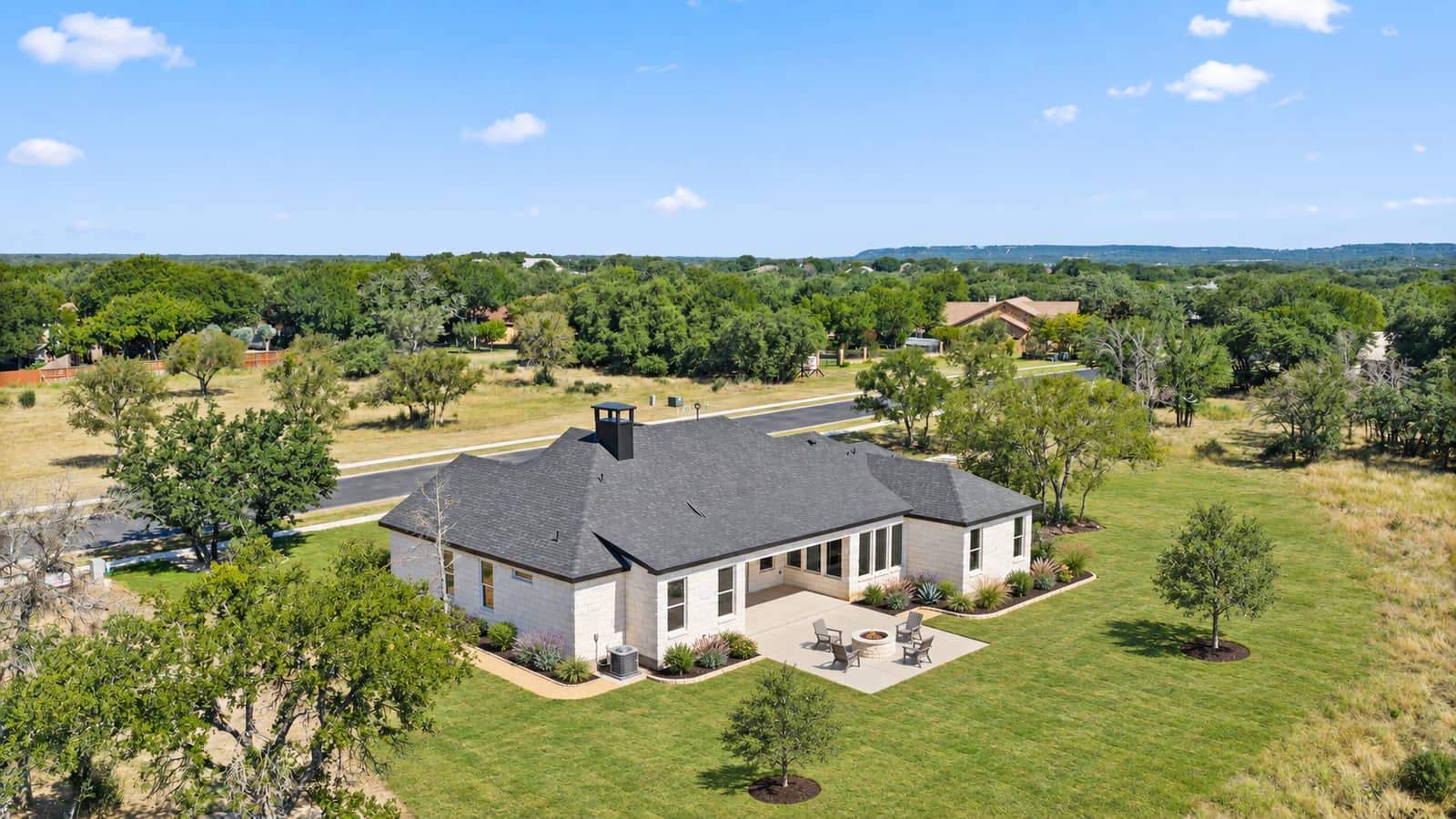 Landscaped aerial rear view of 258 Sunday Drive with its lawn and patio