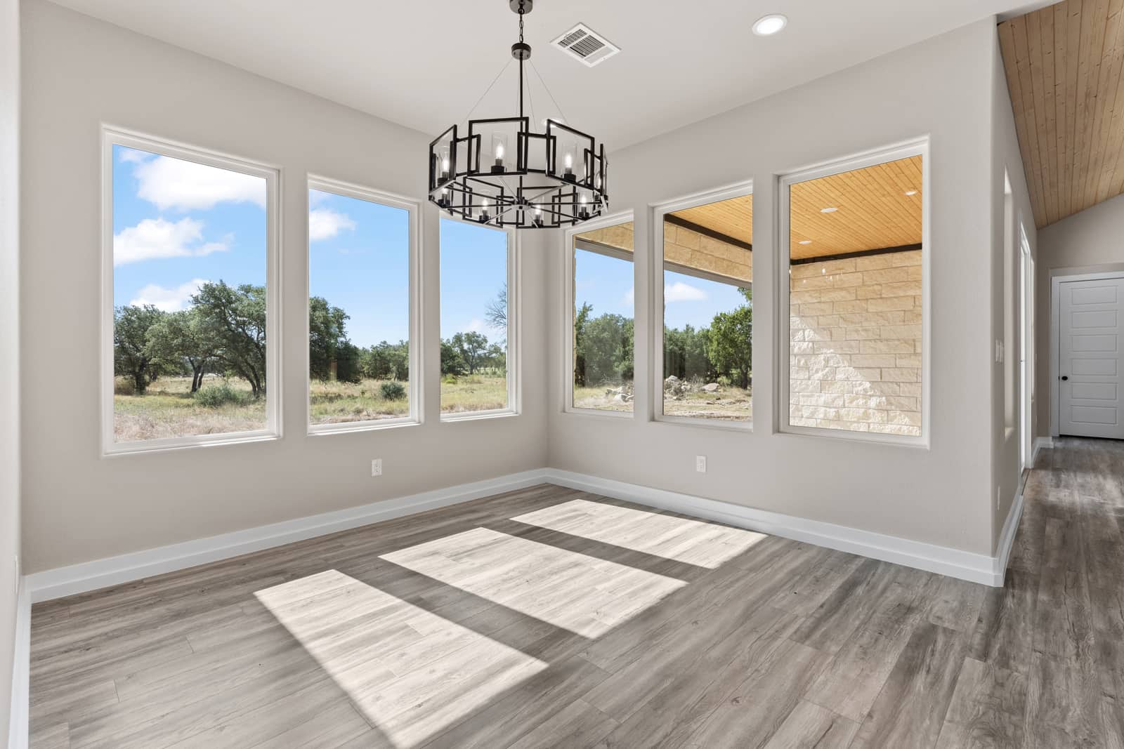Sunlit dining area with Hill Country views at 258 Sunday Drive