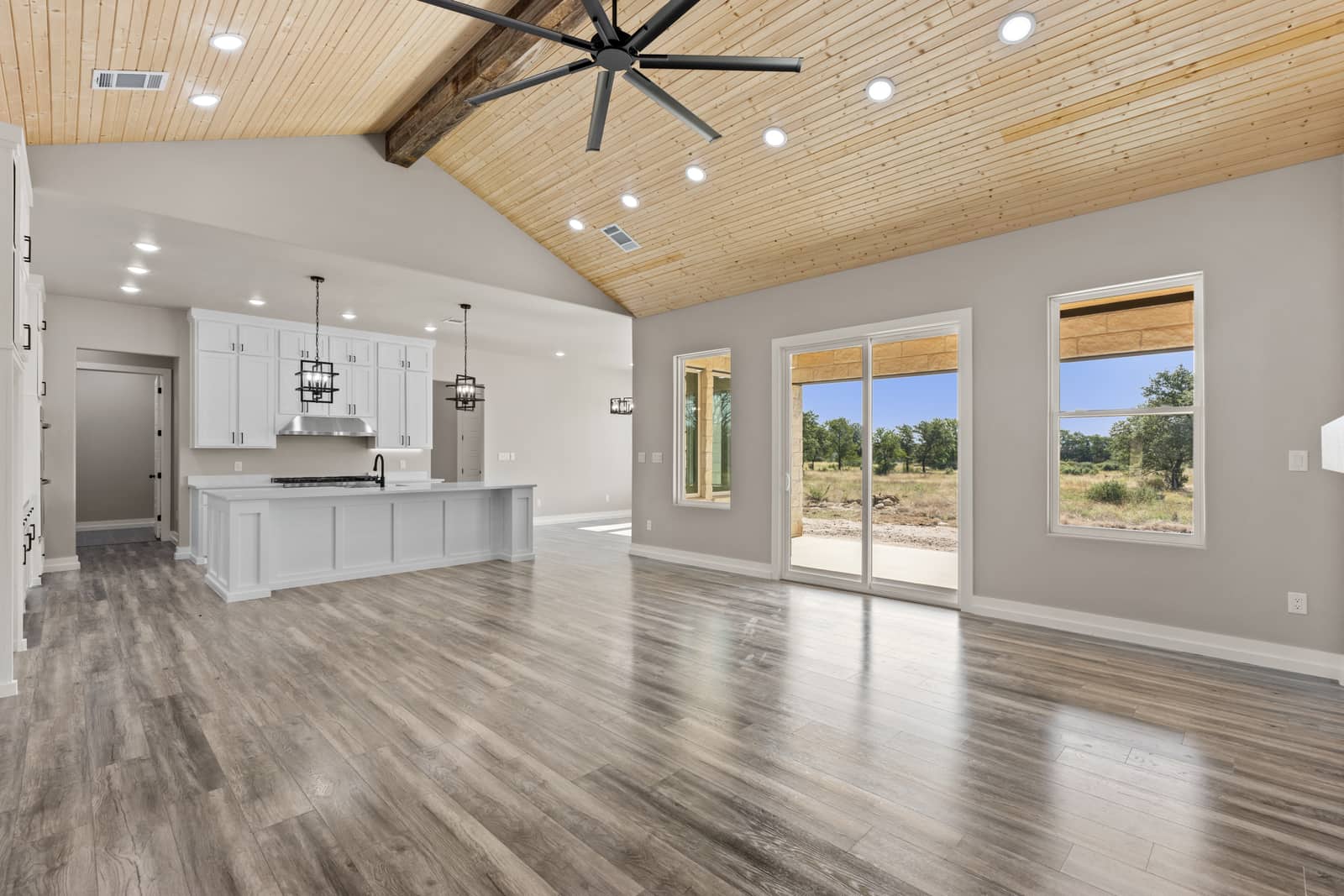 Open kitchen and gathering space beneath a wood ceiling at 258 Sunday Drive