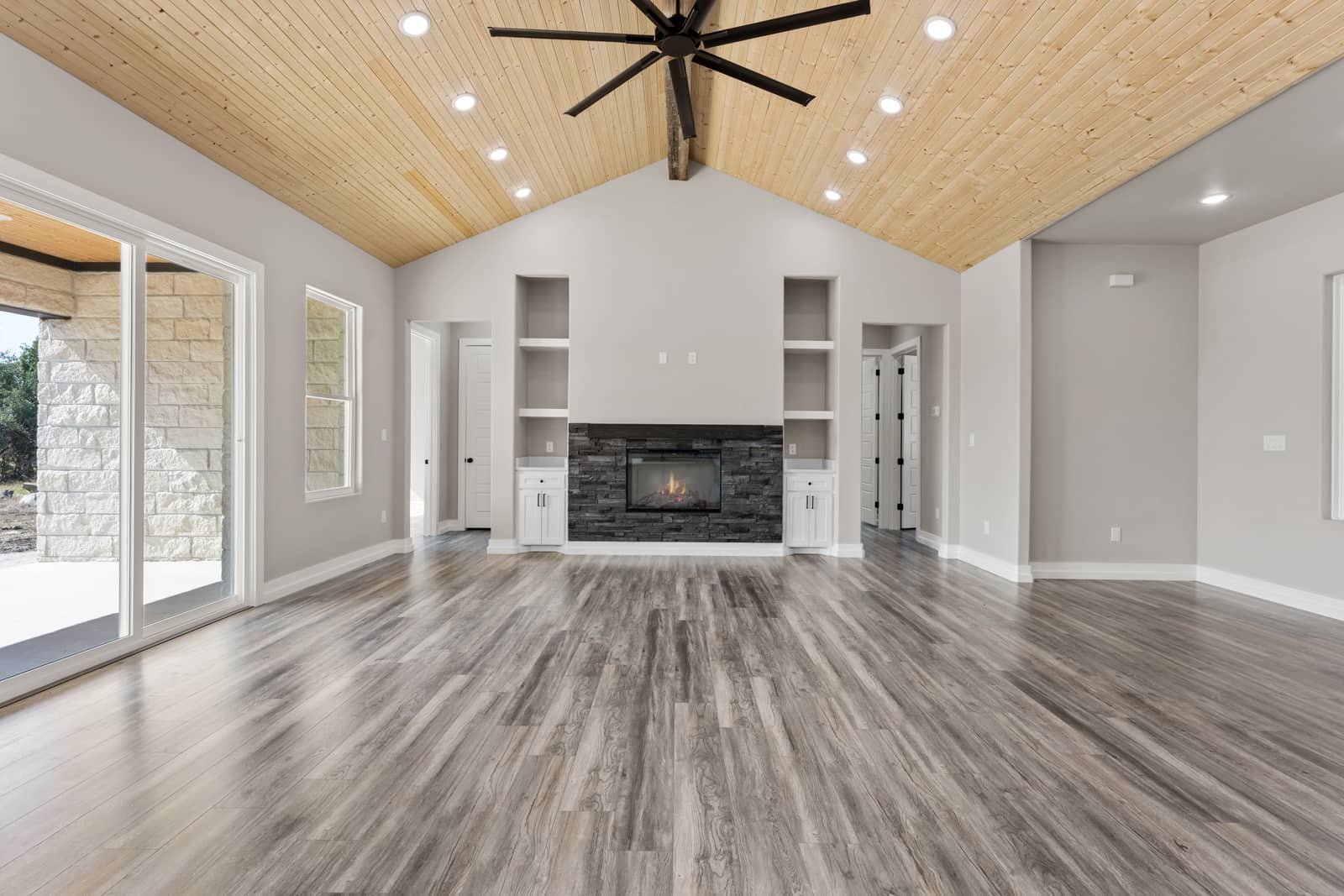Open living room with fireplace and wood ceiling at 258 Sunday Drive