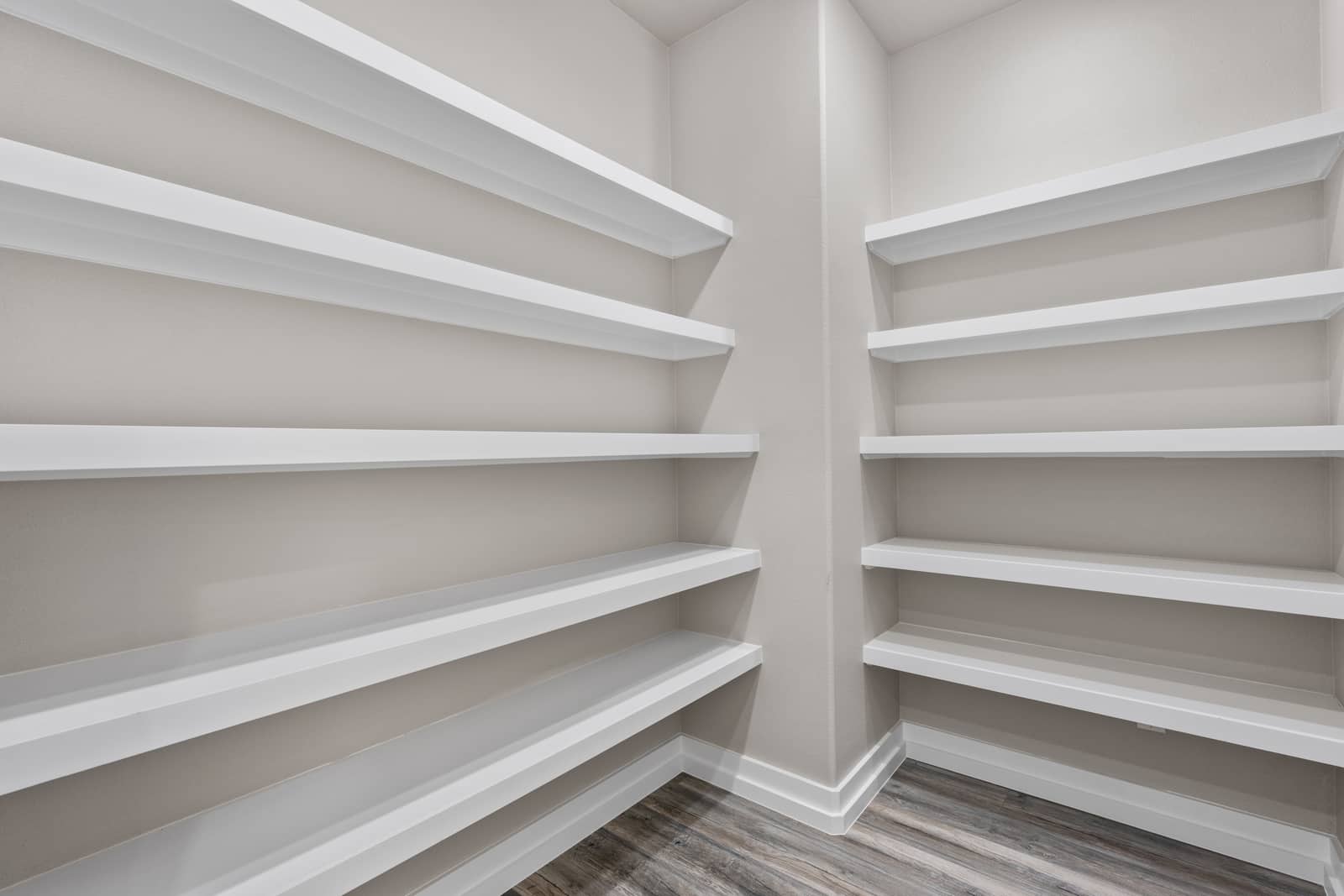 Walk-in pantry lined with open shelving at 258 Sunday Drive