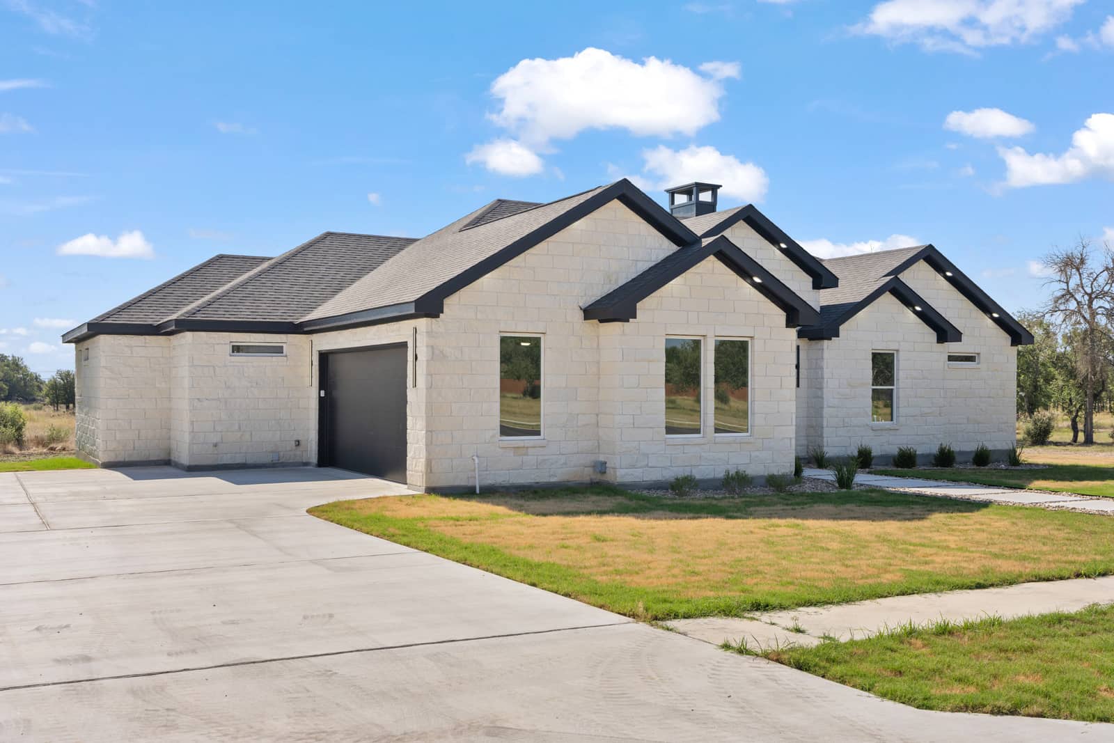Stone exterior and side-entry garage at 258 Sunday Drive