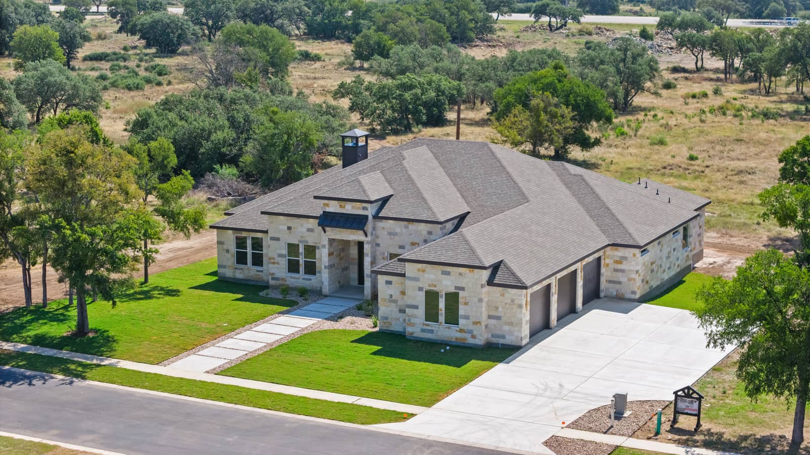 Angled aerial view of the front entry and three-car garage at 262 Sunday Drive
