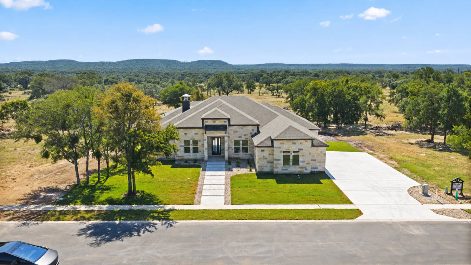 Aerial front view of 262 Sunday Drive against the wooded Hill Country