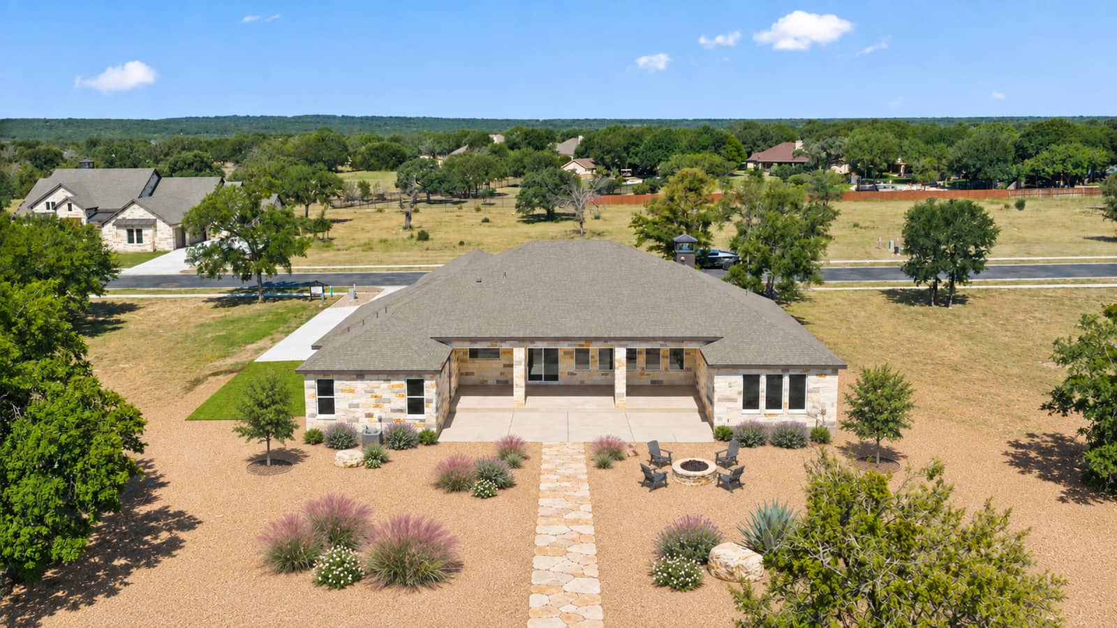 Landscaped aerial rear view of 262 Sunday Drive with its stone path and fire pit