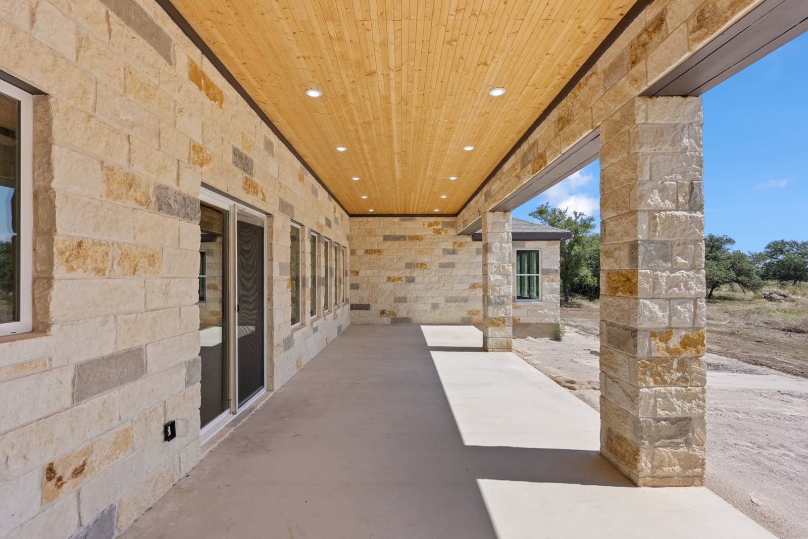 Stone columns and wood ceiling on the covered porch at 262 Sunday Drive