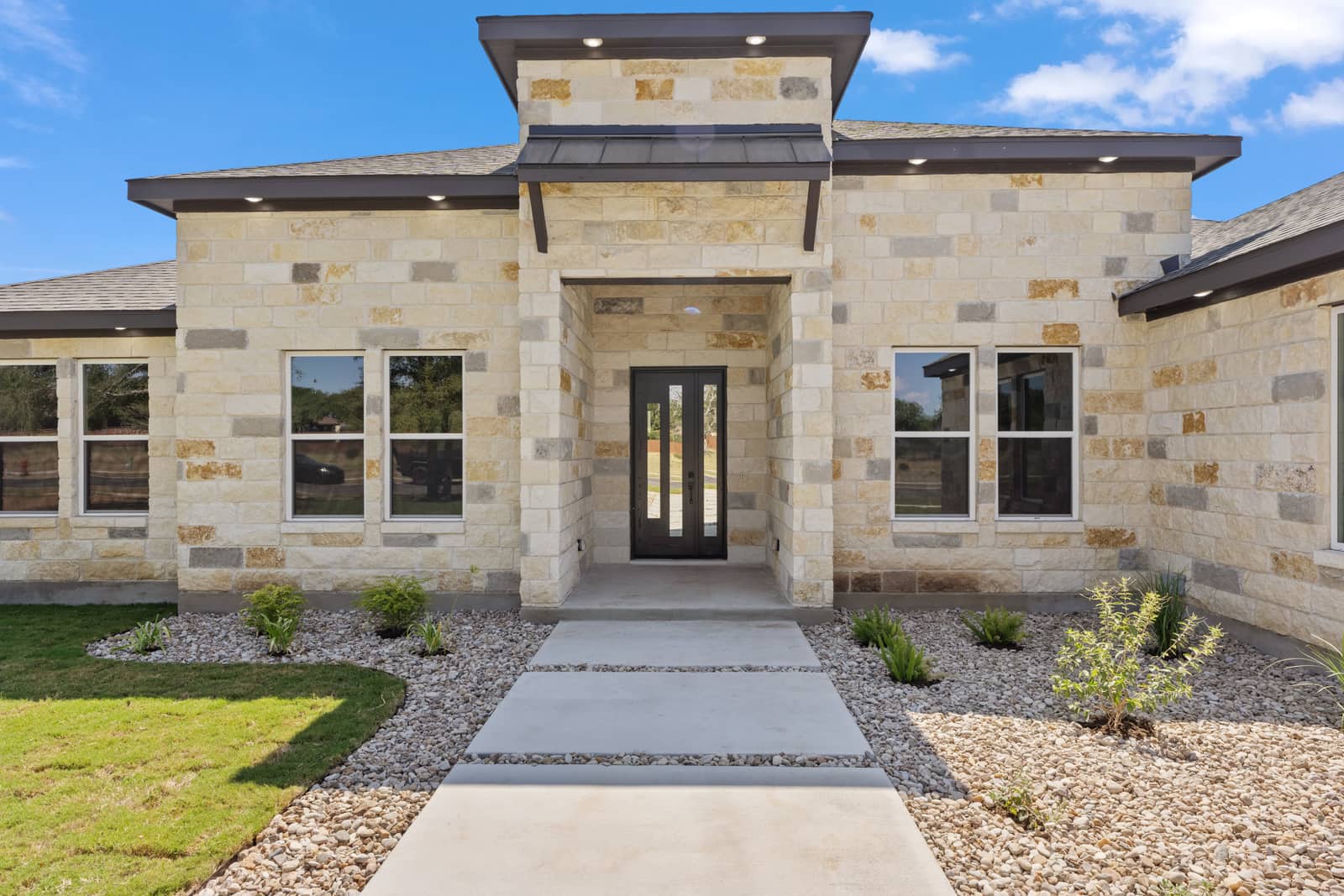Landscaped limestone entry and front door at 262 Sunday Drive