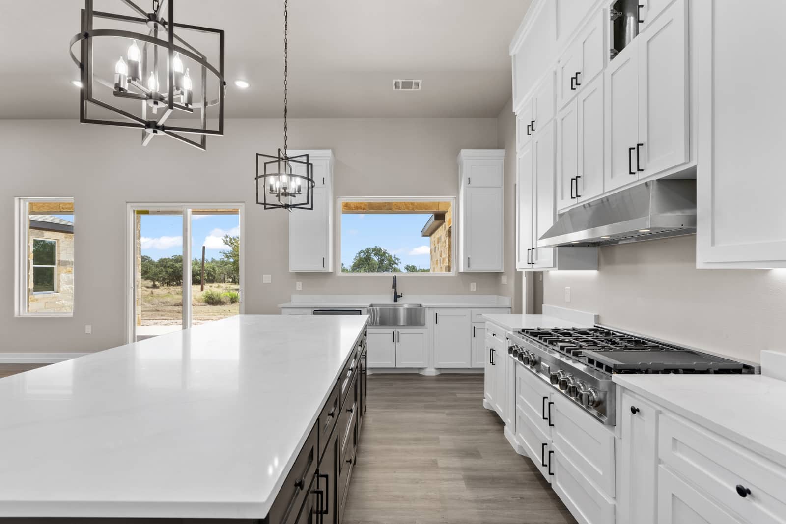Kitchen island, gas range and white cabinetry at 262 Sunday Drive