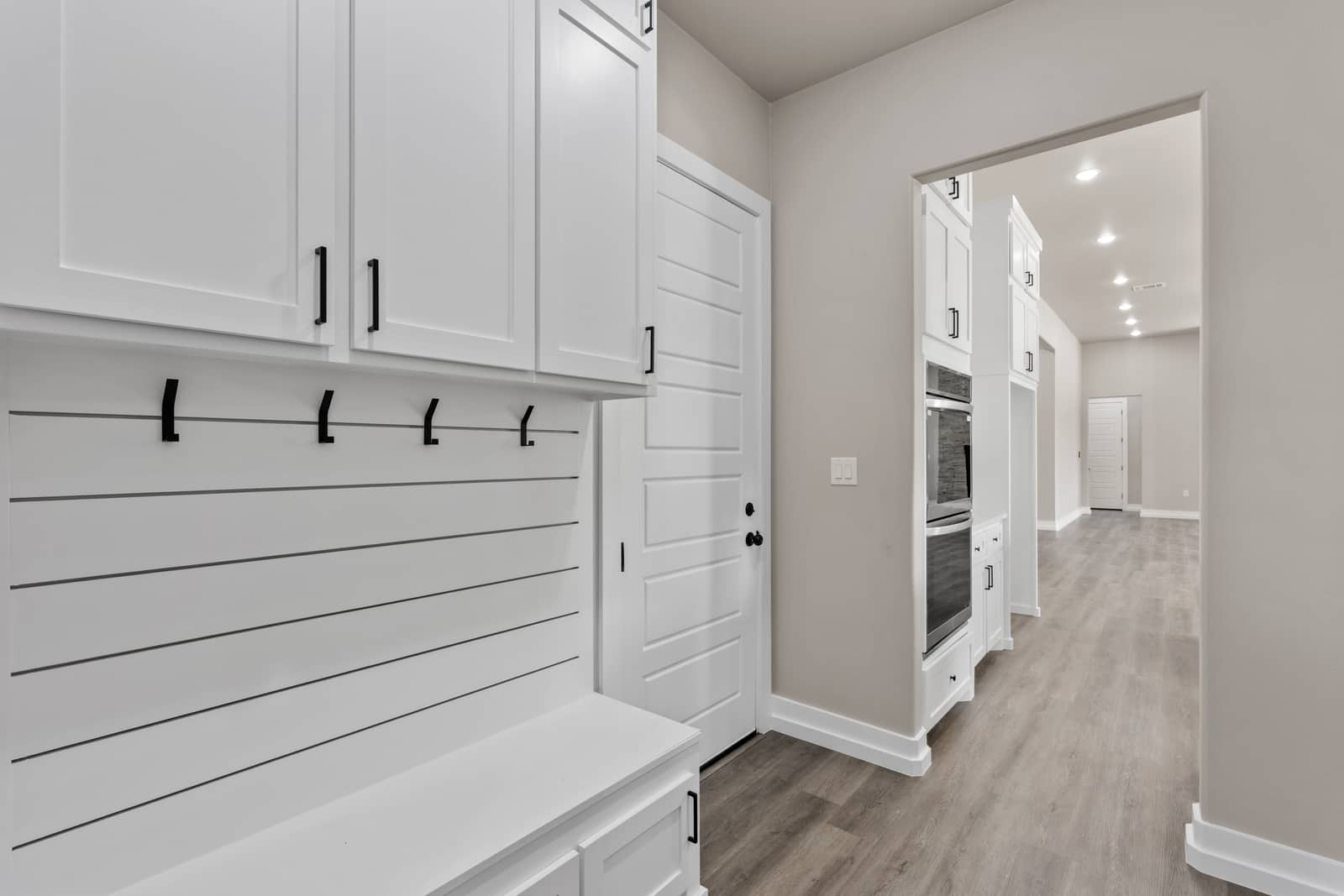 Built-in mudroom bench, hooks and cabinets at 262 Sunday Drive