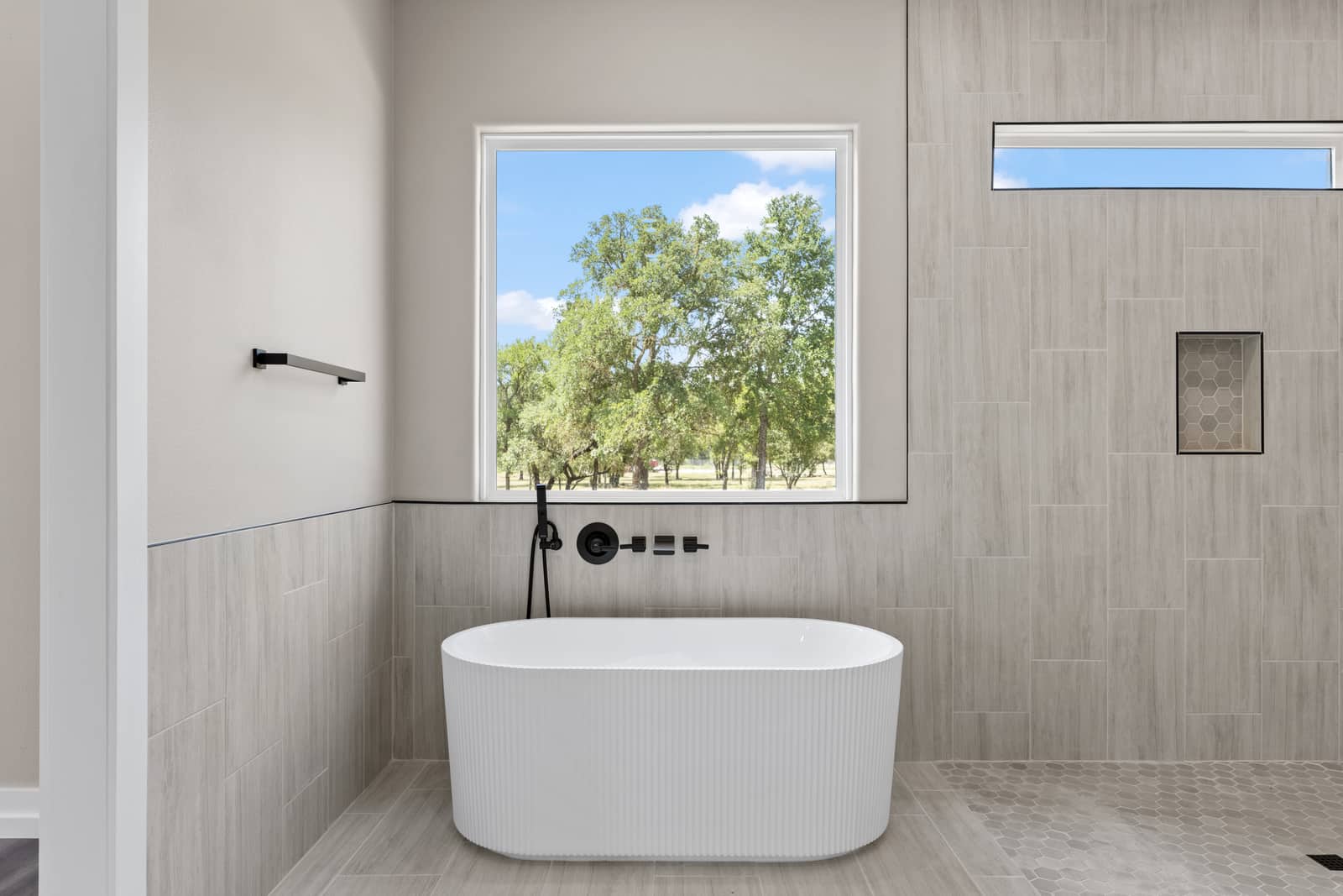 Freestanding tub and tiled wall at 262 Sunday Drive