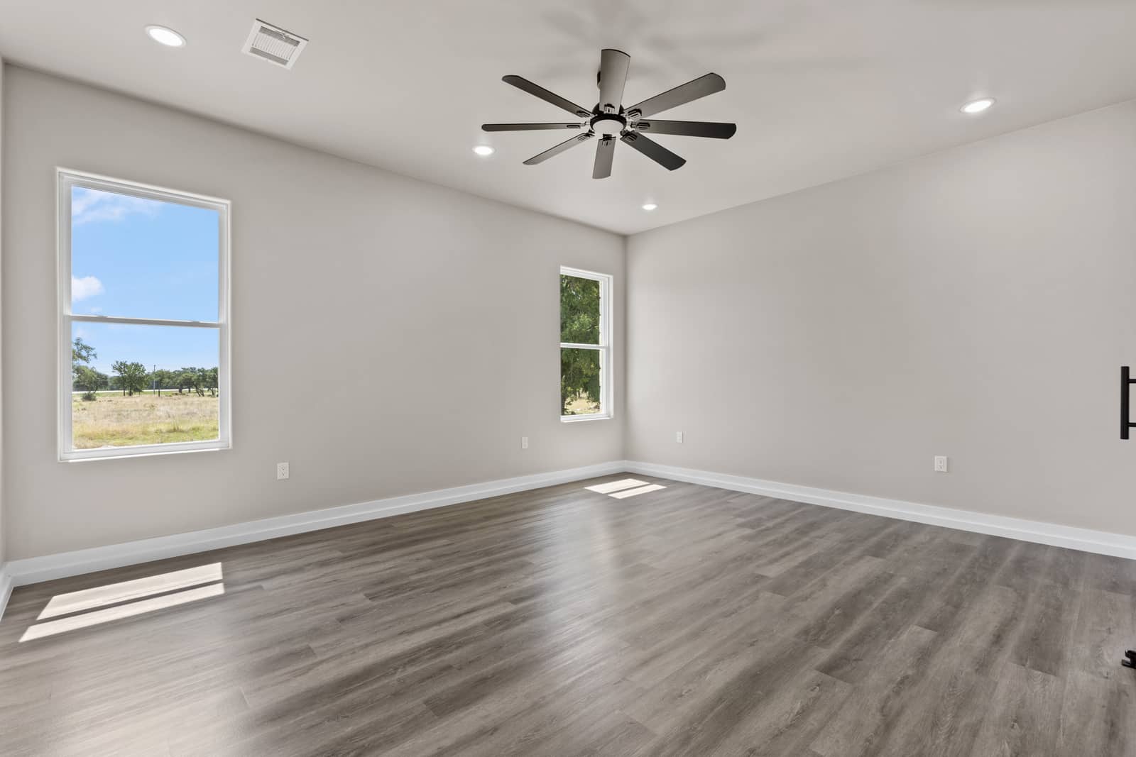 Primary bedroom with two Hill Country windows at 262 Sunday Drive