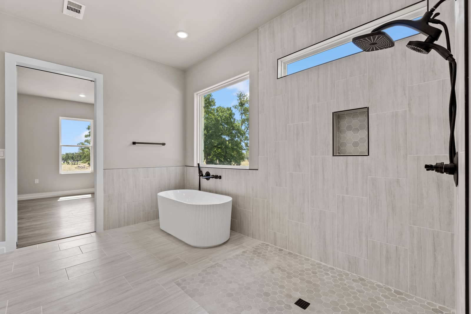 Tiled walk-in shower beside a freestanding tub at 262 Sunday Drive
