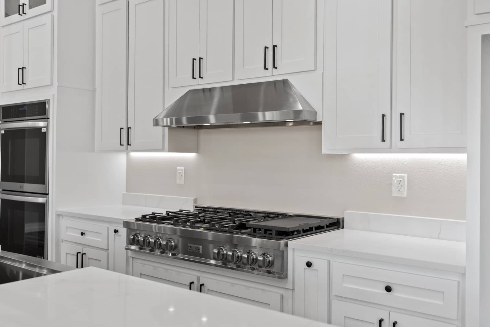 Stainless steel range and white kitchen cabinetry at 265 Sunday Drive