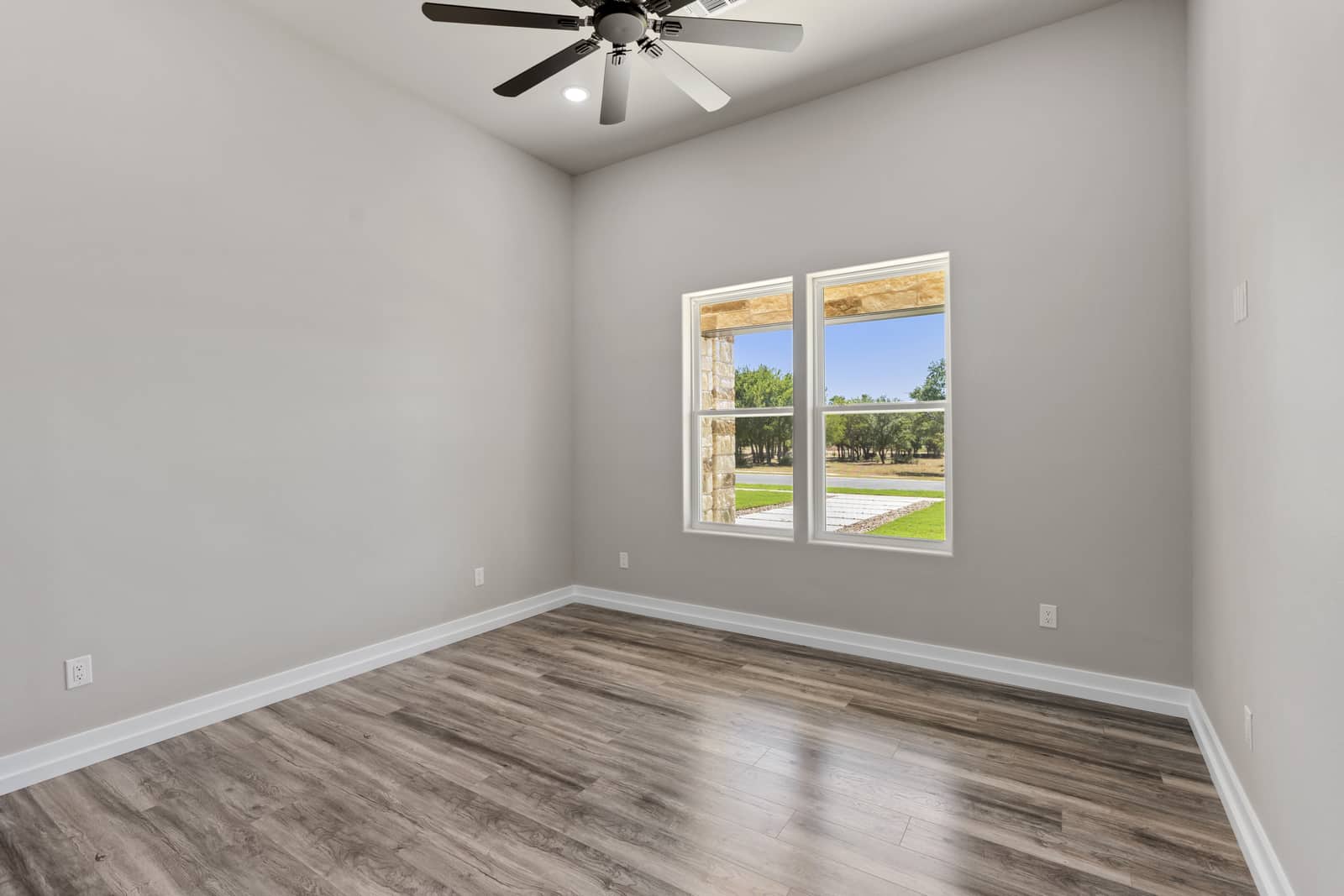 Secondary bedroom with a double window and ceiling fan at 265 Sunday Drive