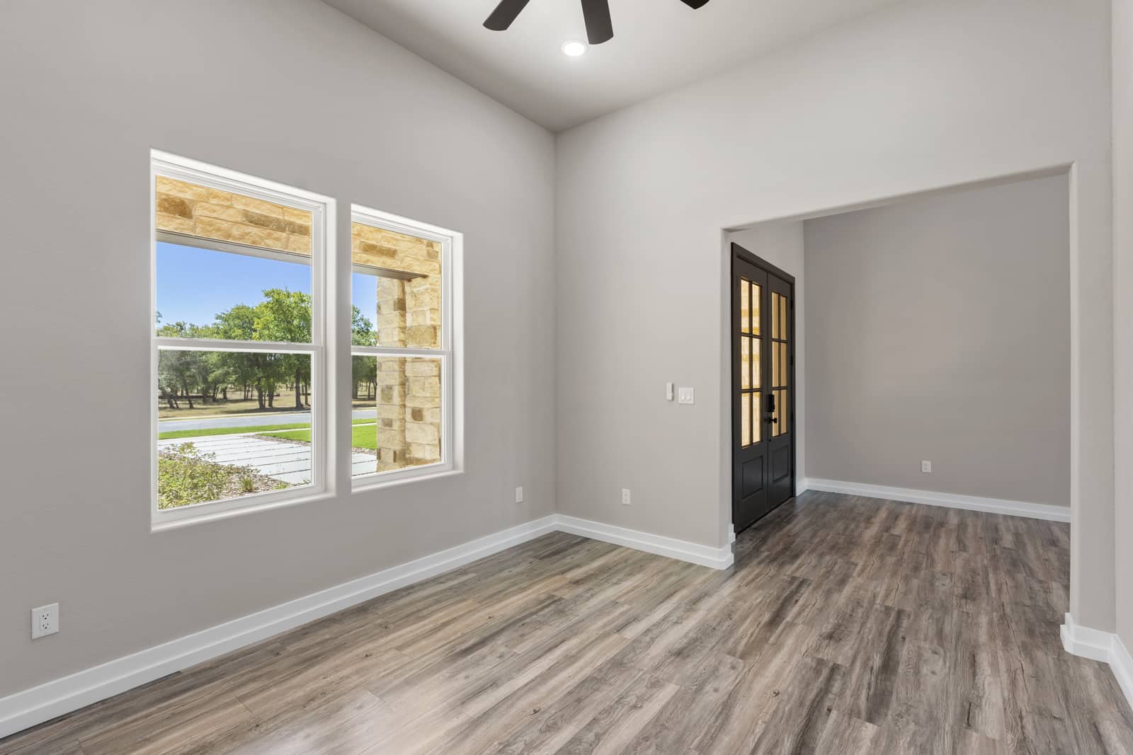 Front room with tall windows beside the entry at 265 Sunday Drive