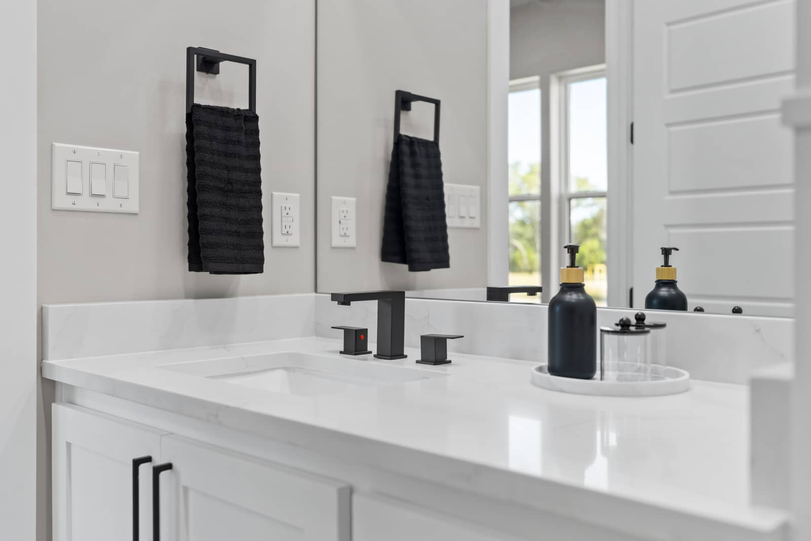 Dark fixtures and paneled vanity detail at 271 Sunday Drive