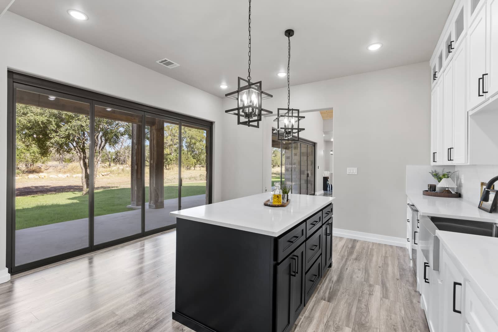 Kitchen island, dining lights and sliding glass doors at 271 Sunday Drive