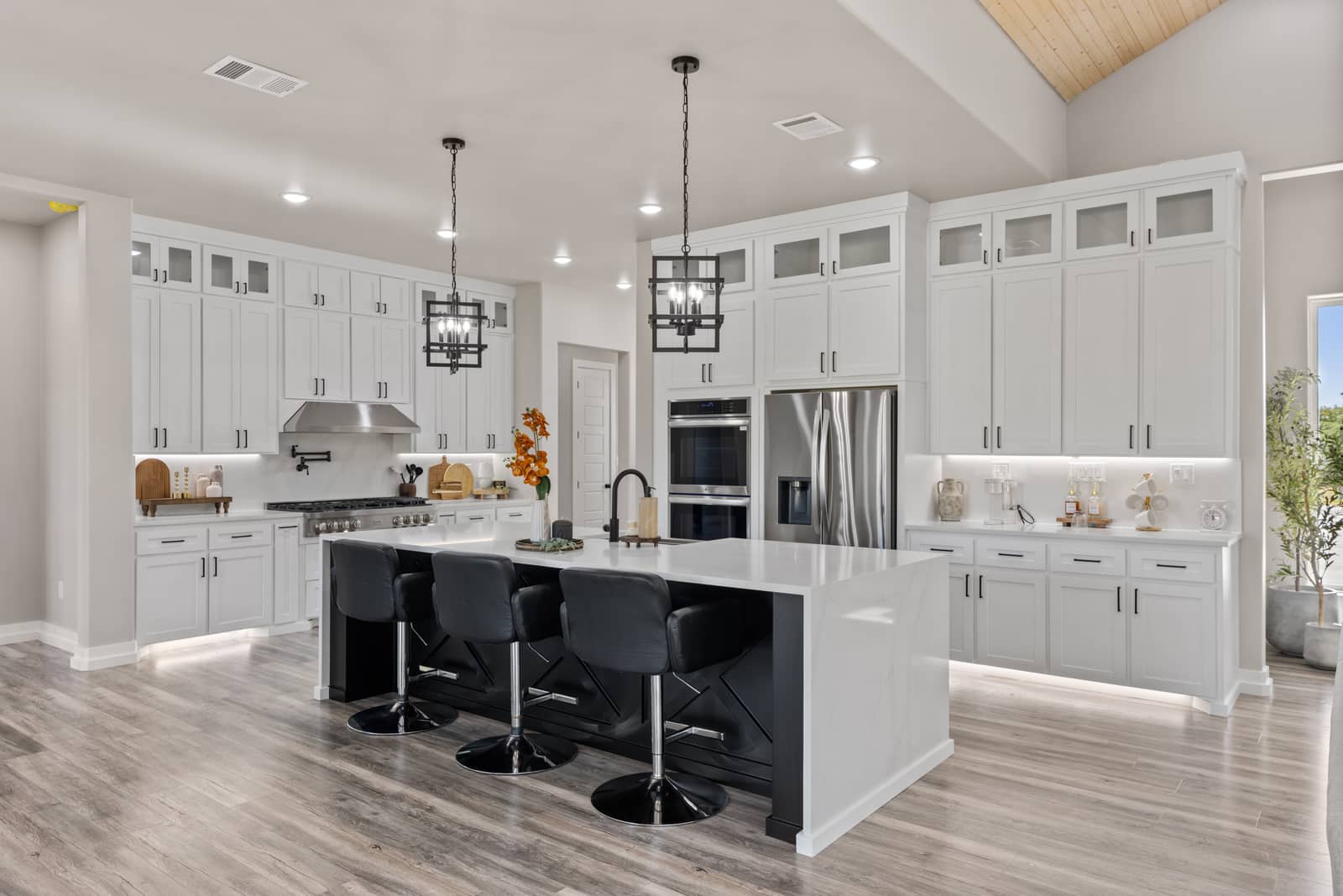 White kitchen with a dark island at 271 Sunday Drive