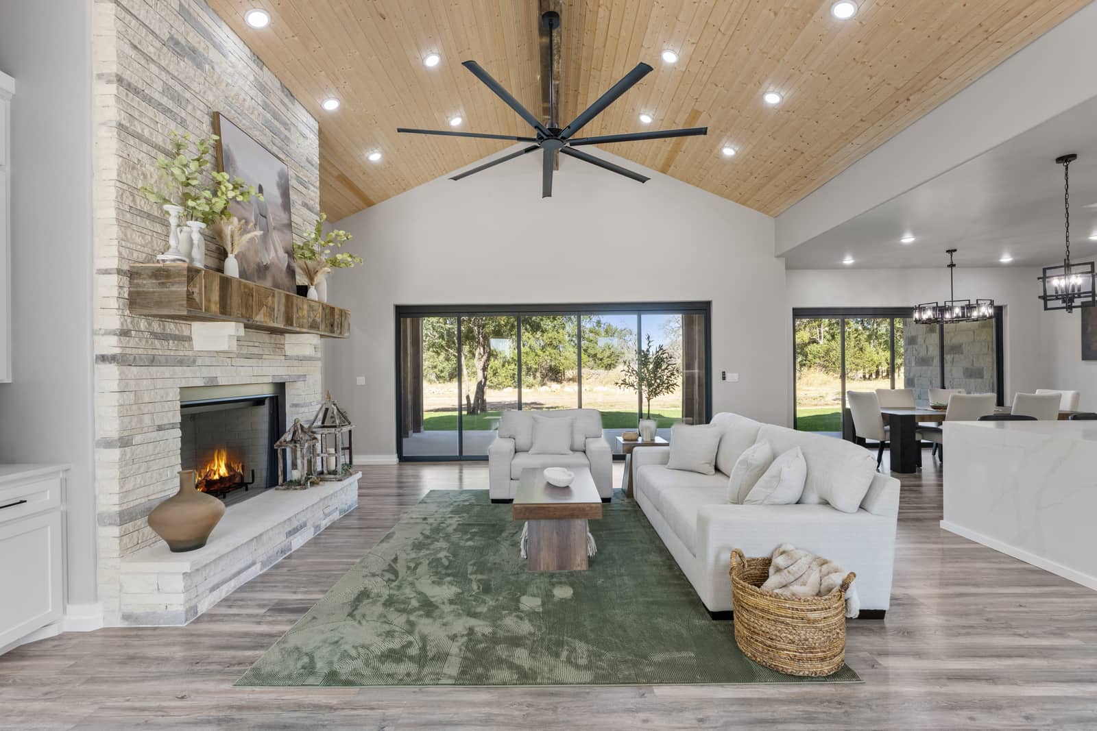 Furnished living room with stone fireplace and wood ceiling at 271 Sunday Drive
