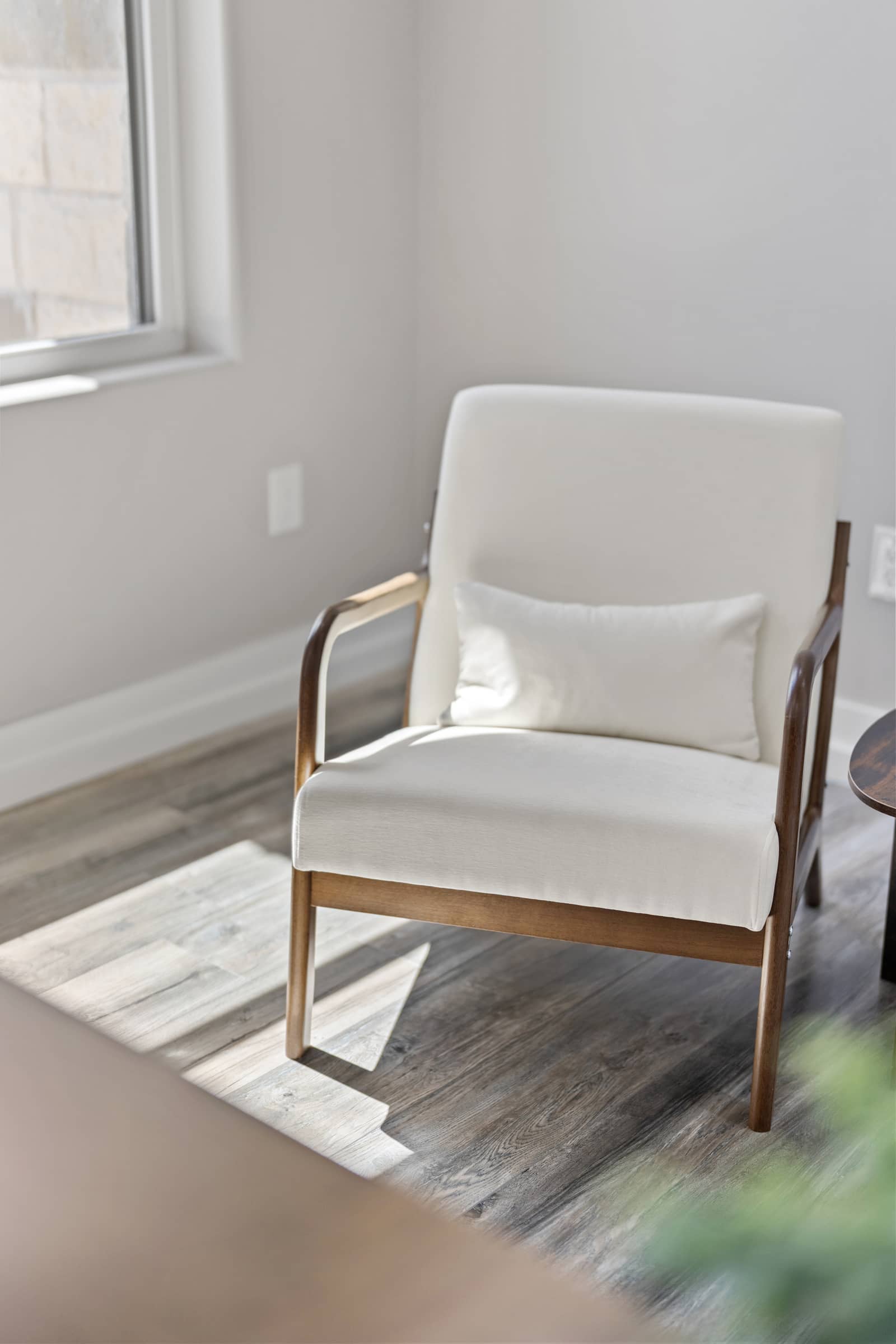 Upholstered reading chair in a sunlit corner at 271 Sunday Drive